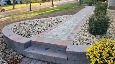 This nice new walkway, built by Black River Landscape Management, won’t look good for long unless leaves are removed regularly. If left on the walkway, wet leaves will stain the pavers. Photo: Black River Landscape Management