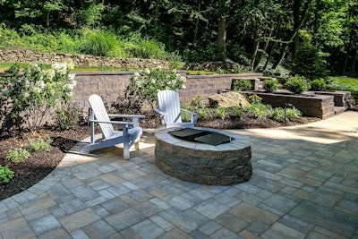 Fire pits function essentially the same as outdoor fireplaces but typically cost significantly less. Photo: Black River Landscape Management