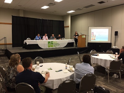 Pam Berrios, president-elect of the National Hispanic Landscape Alliance, moderates a panel discussion for equipment dealers at GIE+EXPO. Photo: David Rountree