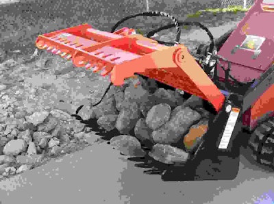 The new grapple is designed to retain rocks while allowing dirt to be sifted out of the bucket. Photo: Worksaver Inc.