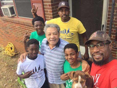 After finishing a job, Smith and his young men will take a picture with the homeowner they helped. Photo: Raising Men Lawn Care Service
