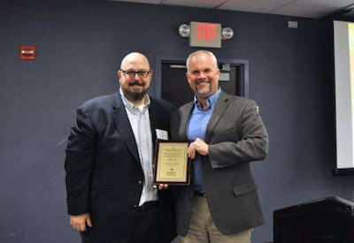 STIHL’s corporate communications manager, Roger Phelps, accepts award from NRHA Vice President of Publishing Dan Tratensek.