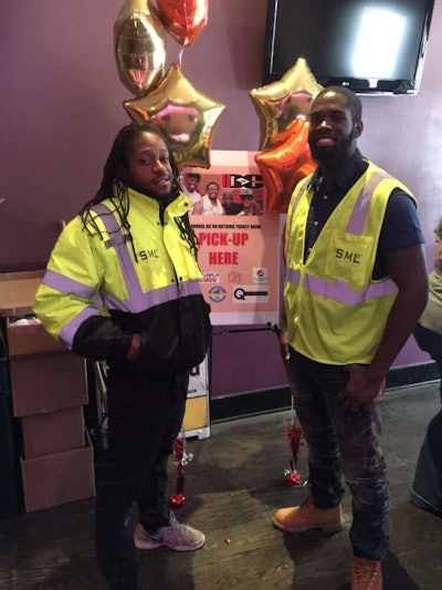Jerell Brown (left) and an employee pose at the 2016 DC or Nothing Turkey Drive. Photo: Yelp
