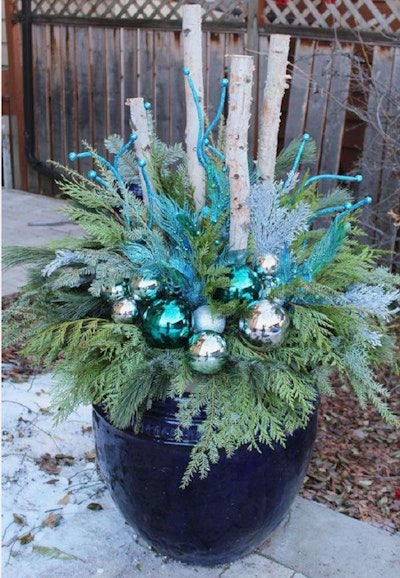 This nontraditional winter container uses silver and blue colors as its focus. Photo: Gardening – A Creative Journey