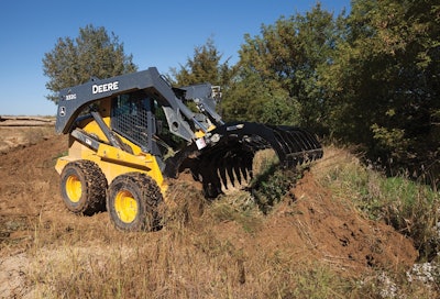 The height and width of the root rakes help protect the front of the machine from damage. Photo: John Deere