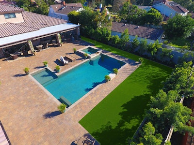 Although their client was pleased with Hillside Pavers’ hardscape work, they didn’t like the look of their lawn next to it. Hillside solved the problem by installing more than 1,500 square feet of artificial grass for the client. Photo: Synthetic Grass Warehouse