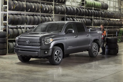 Man Loading Tires into the 2018 Toyota Tundra