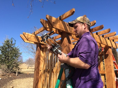 As director of operations for Kinghorn Gardens, Dan Moore knows which crews to assign to what projects based on their skills. This Kinghorn Gardens employee works on building a pergola. Photo: Kinghorn Gardens