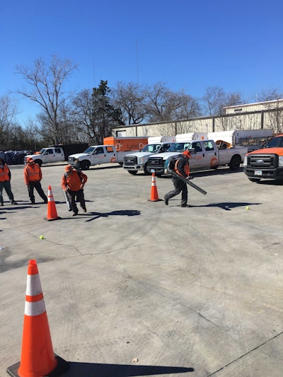 Employees competed to blow a tennis ball into a trash can. Photo: LandCare