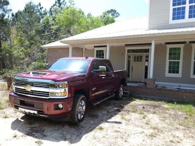 2017 Chevy Silverado backed up to a house