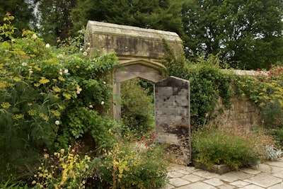 hardscaping and wooden built secret garden gate opening