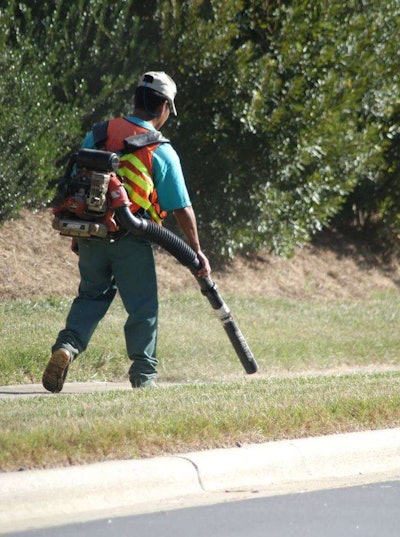 landscape worker with blower