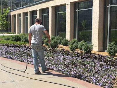 A worker waters plant beds at the Lauritzen Gardens in Omaha, Nebraska. Photo: Jill Odom/Total Landscape Care
