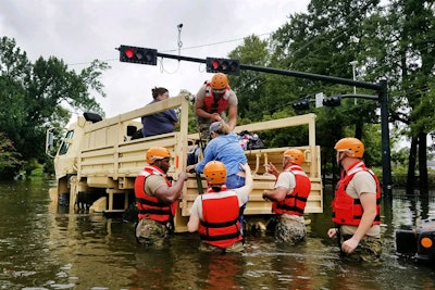 Texas National Guardsmen help evacuate residents affected by flooding. Photo: Department of Defense