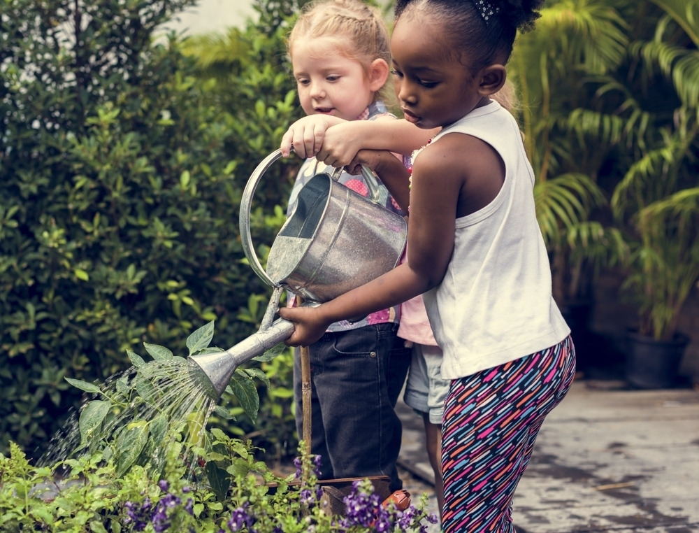 little-girls-watering-can