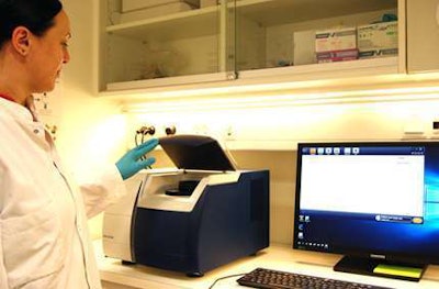 The sample cup is placed in the spectrometer for visible near-infrared spectroscopy measurement. The measurement takes approximately one minute and the spectrum is visualized on the computer screen for immediate quality check. Photo: Maria Knadel