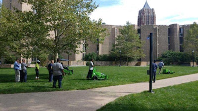 Facilities grounds staff test the performance of electric mowers on campus. Photo: Mark McCloud