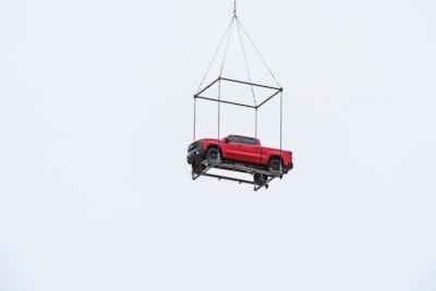 chevy on platform under helicopter
