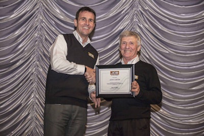 JCB North America president, Richard Fox-Marrs (left) congratulates aftermarket sales specialist, John Carter, on his 40 years of service with JCB. Photo: JCB