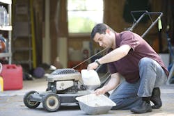 a-man-working-on-his-lawnmower-