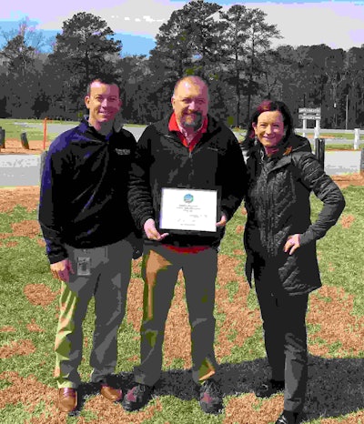 Jimmy Simpson, STMA (left) and Cindy Code, Project EverGreen (right), present Jonathan Allen, City of Clinton Parks and Recreation, with a new Exmark mower. Photo: Project EverGreen
