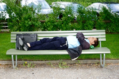 man sleeping on bench