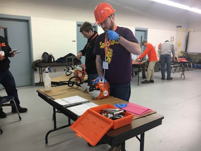 Finalists worked to repair their Stihl engines. Photo: Jill Odom