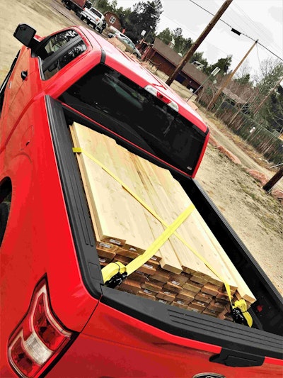 Red Diesel Ford F-150 up close photo of truck bed loaded with wood planks