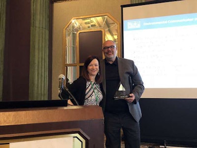 The City of Detroit’s Bradley Dick (right) accepts the Environmental Communicator Award on behalf of Detroit Mayor Mike Duggan from Project EverGreen’s Cindy Code. Photo: Project EverGreen