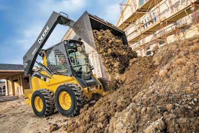 photo of john deer compact loader on dirt filled construction site
