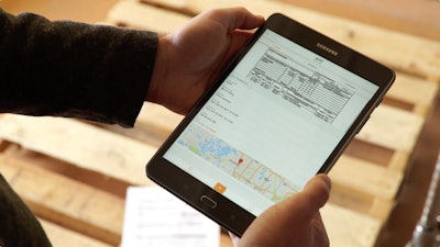 person holding samsung tablet with LoadDocs app open