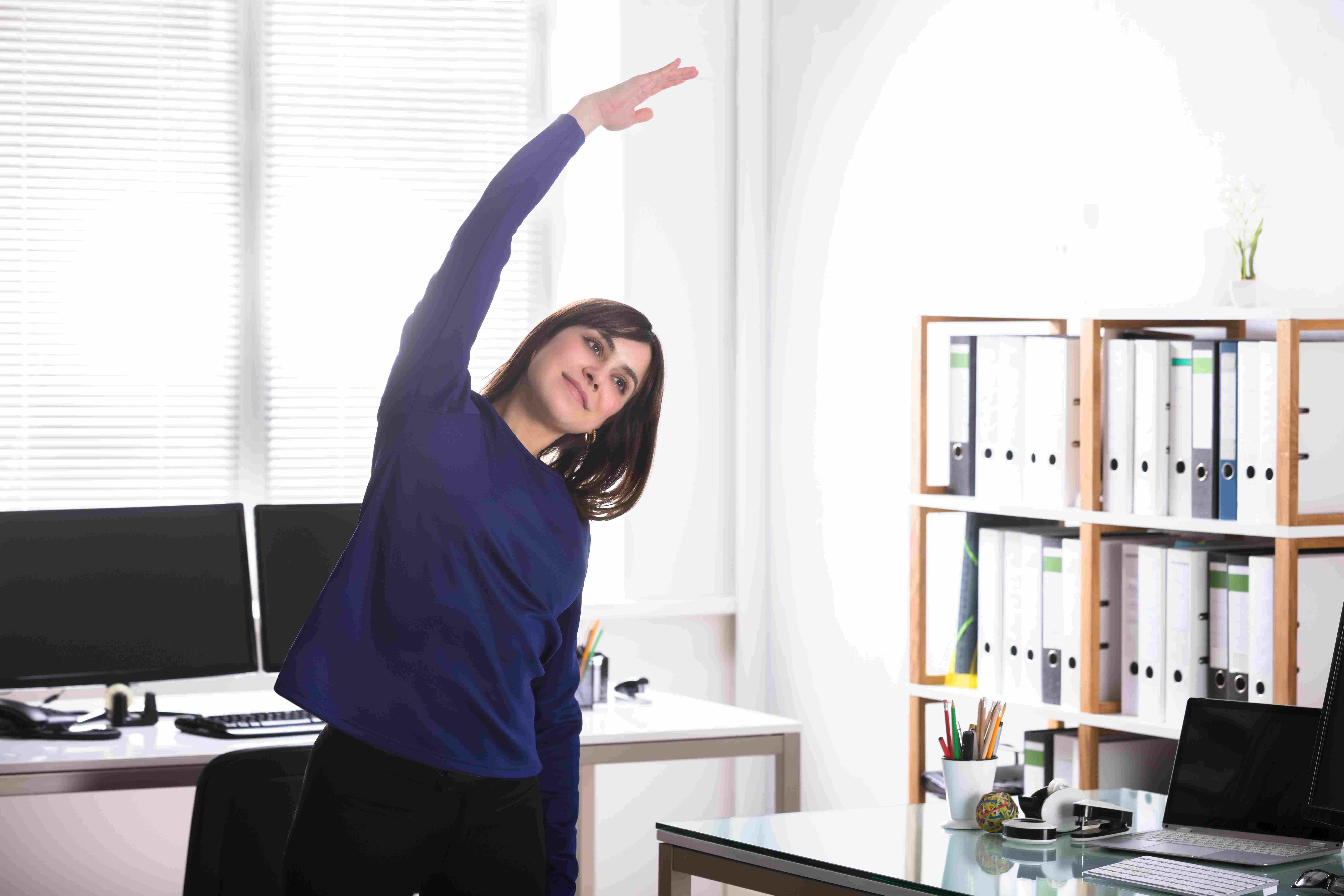 woman-stretching-in-office