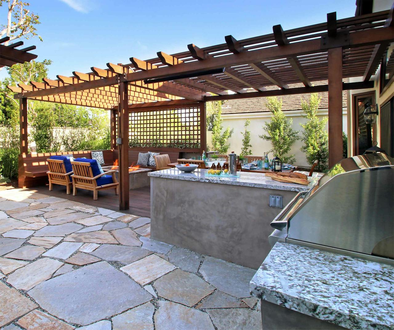 Gliksman created an outdoor kitchen that featured a covered dining area, a covered fire pit complete with built-in benches, an open patio, a swing and an entire garden. Photo: Urban Oasis Landscape Design