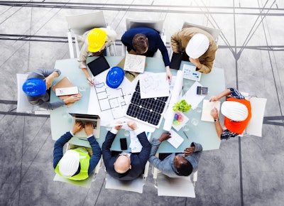Construction project workers reviewing job plans