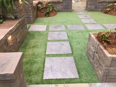 Instead of trying to coax grass to grow between pavers, Bennett opts for artificial turf. Photo: Bennett Design & Landscape