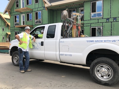 Eric Schultz, left, talks to one of his employees about the scheduling at a current jobsite. Photo: Jill Odom