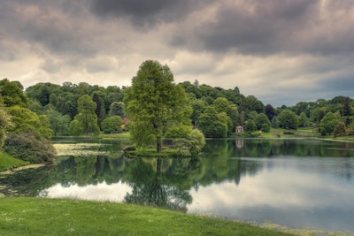 Beautifully landscaped lake with tress surrounding it
