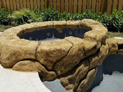 The rock waterfall pictured here was created using a concrete squeeze pump, which was the ideal solution for Pool Crafters to preserve the detailed process of rock carving. Photo: Blastcrete