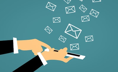 Email icons floating above a hand holding a smart phone