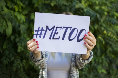 Female holding up #METOO sign