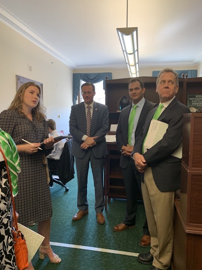 (Right) Arnulfo Hinojosa, VP of the Federation of Employers and Workers of American (FEWA), and Jay Williams talk with Rep. Michael Cloud (left). Photo: Beth Hyatt/Total Landscape Care.