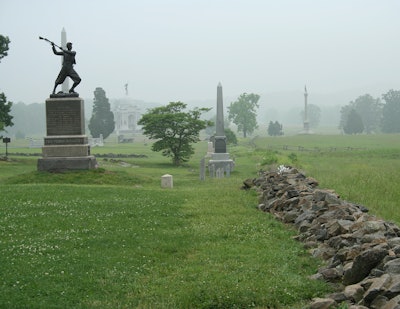 Throughout Pennsylvania and other nearby states, stone walls originally created by farmers as they cleared their fields of stones were used as skirmish lines on the battlefield. These same design elements were echoed along walkways in and around the visitor center both for visual effect and to stabilize the slope and control erosion. Forty tons of local quarried rocks and boulders were used to create stone rubble walls, and river rock was installed to eliminate drainage issues. Photo: Ruppert Landscape