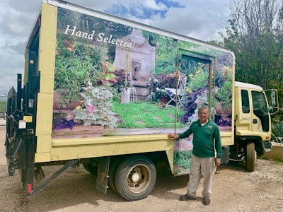 Mora Jr. poses with a special Lambert’s truck featuring one of his favorite project sites. Photo: Beth Hyatt/Total Landscape Care