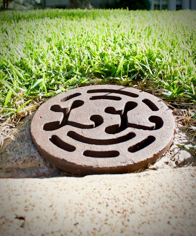 On select properties in Dallas, a few of the original Lambert’s Landscaping water main covers can still be found. Photo: Beth Hyatt/Total Landscape Care
