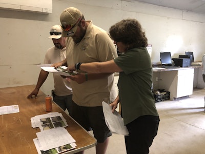 At dispatch, CRM program managers go over any last minute details in job packets. Photo: Jill Odom/Total Landscape Care
