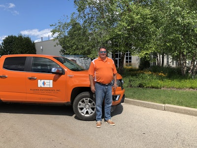 Chris Kajawa, president of KEI, stands with one of the company’s well-known orange trucks. Photo: Jill Odom/Total Landscape Care