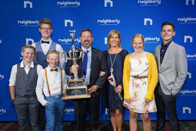 Owners Chris and Juanita Draaistra celebrate earning the Franchise of the Year award with their five children. Photo: The Grounds Guys, a Neighborly company
