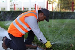 landscaper-adjusting-irrigation-sprinklers.jpg
