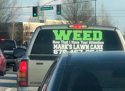 Mark's Lawn Care window decal on the back window of a truck