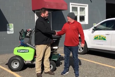 Mitch Foster (right), took delivery in mid-February of a new Turfco T3100 riding spreader and aerator from Brad Hendrickson, regional sales manager, Turfco Manufacturing. Photo: Turfo